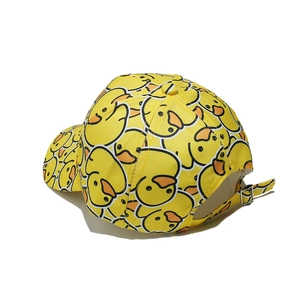 Close-up of yellow baseball cap with cartoon duck prints and adjustable metal buckle