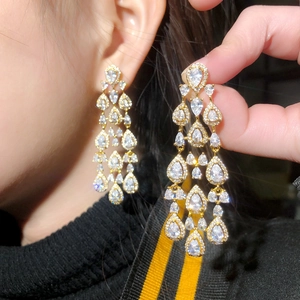 Elegant gold drop earrings featuring pear-cut cubic zirconia and long tassel pendant