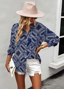 Outdoor shot of long-sleeved shirt with blue paisley print and white buttons