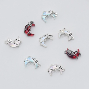Flat lay of moon shaped Halloween alloy pendants with colorful synthetic stones