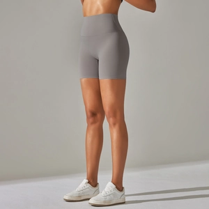 Close-up of grey high-waist yoga shorts showing seamless shaping and peach lift effect