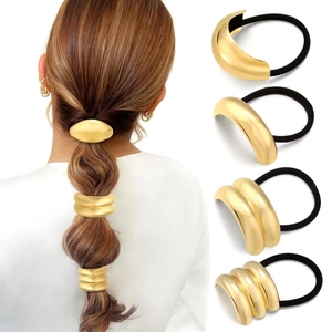 Detailed close-up of four-piece gold metal ponytail cuff set with elastic hair ties
