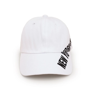 Detailed close-up of white cotton baseball cap with black New York embroidery on the side