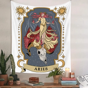 Detail of Aries zodiac tapestry with mystical sun and moon motifs hanging on a wall