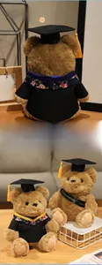 Detail of plush graduation teddy bear with black academic gown and yellow tassel hat