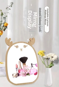 Close-up of minimalist wooden desktop makeup mirror with cute decorative deer antlers