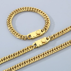 Polished gold curb chain necklace and bracelet set with industrial gear style clasps