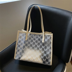 Large transparent PVC tote bag with beige leather trim and monogram M pattern