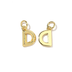 Close-up of 18K gold-plated letter D charms with cubic zirconia for DIY jewelry making