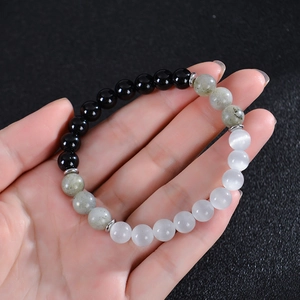 8mm natural moonstone and obsidian beaded bracelet with silver spacers on hand