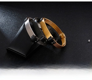 Detail of stainless steel mesh bracelets in silver, black and gold with folding clasps
