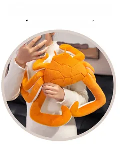 Close-up of a large soft plush king crab pillow with realistic orange textured stitching