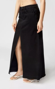 Detail of black denim maxi skirt featuring a high front slit and raw hem finish