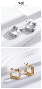 Detail showing geometric gold and silver square hoop earrings with multi-layered metal lines