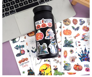 Waterproof laser Halloween stickers on a black water bottle featuring pumpkin and bat motifs