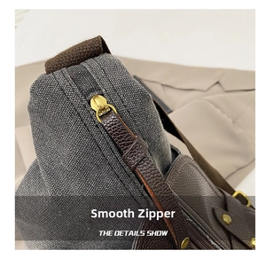 Detailed close-up of smooth zipper with canvas and leather patchwork textures