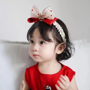 Detail of red polka dot bow headband with gold crown and white lace for baby girls