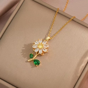 Elegant gold sunflower necklace with white zircons and green gemstone leaf pendant