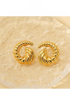Detail view of gold-plated titanium steel earrings with a spiral twisted rope texture