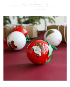 Detailed view of red and white Christmas balls with vintage car prints and green ribbons