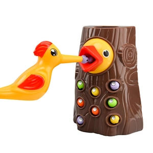 Magnetic woodpecker feeding toy with colorful balls and a brown tree stump for kids