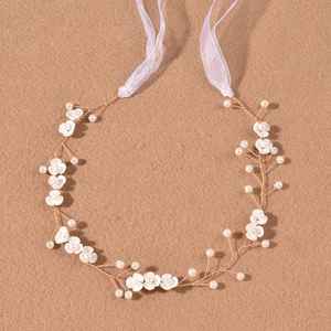 Exquisite bridal headband with white handmade flowers and pearls on golden wire
