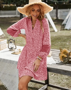 Close-up of red floral dress featuring intricate lace stitching on the sleeves