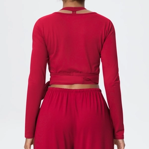 Detail of dark red wrap sports top showing the criss-cross back straps and fabric texture