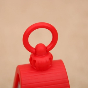 Macro shot of the bright red plastic handle and ring hook of the Christmas lantern