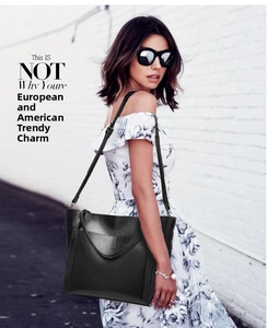 Chic black wax leather tote bag shown in a city street setting for a modern look