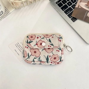 Detailed view of floral quilted fabric card holder with secure metal keyring hook
