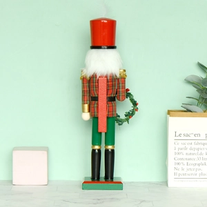 38cm wooden Nutcracker soldier in red and green festive outfit with Christmas wreath
