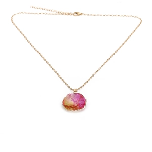 Detail of gold chain necklace with colorful gradient irregular stone pendant and clasp