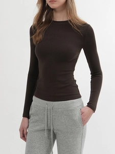 Detailed view of the fine ribbed texture on a slim fit dark brown long sleeve crewneck top