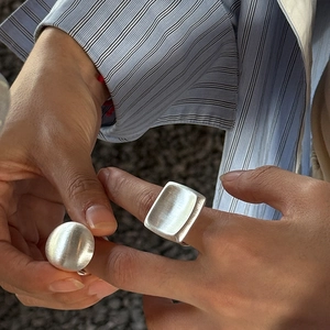 Minimalist brushed silver rings featuring geometric oval and rectangular dome designs