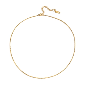 Detail of a golden stainless steel box chain necklace with a lobster clasp and tag