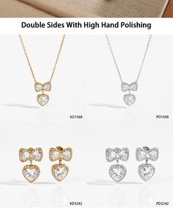 Polished bow and heart zircon necklace and earring set in gold and silver finishes