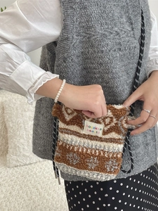 Fleece heart crossbody bag with geometric snowflake pattern and woven shoulder strap