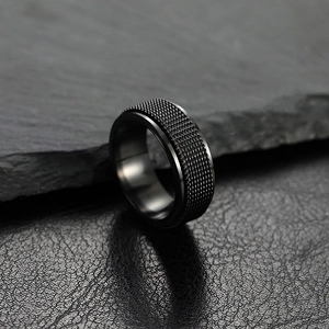 Mens 8mm black stainless steel ring with mesh inlay on rock and leather background