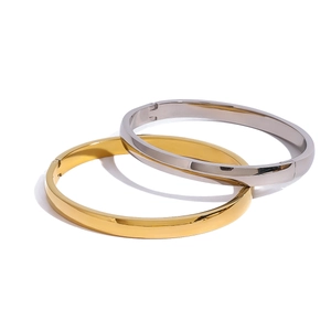 Polished stainless steel flat oval bangles in gold and silver with side clasp closure