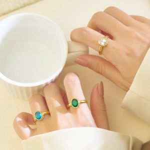 Retro stainless steel oval ring with colorful zircon stones on female hand