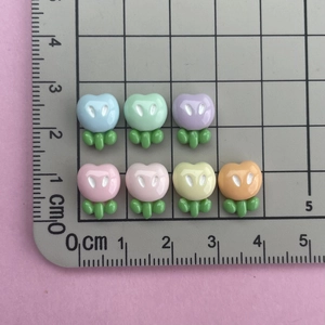 Detailed scale view of 1cm glossy resin flower charms for DIY nail art and crafts
