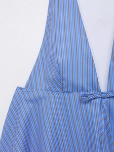 Detailed view of striped halter neck top featuring a deep V-neck and decorative bow tie
