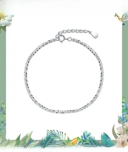 Macro detail of S925 sterling silver chain bracelet with lobster clasp and stamp charm