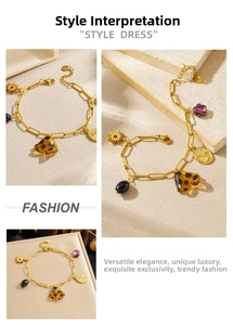 Detailed close-up of gold stainless steel charm bracelet with leopard print and sun charms