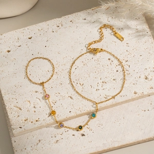 Detail of 18K gold plated stainless steel finger chain bracelet with five colorful gems