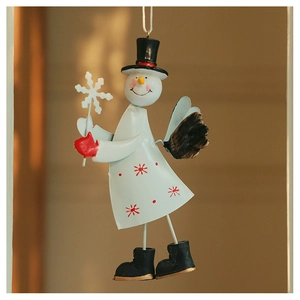 Detail of hanging metal snowman ornament with red snowflake print and smooth finish