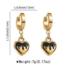 Detail showing gold heart earrings with black drip enamel, sizing 1.3cm wide by 3.1cm long