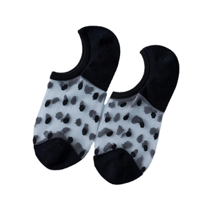Women's sheer crystal glass socks featuring elegant black polka dots on white background