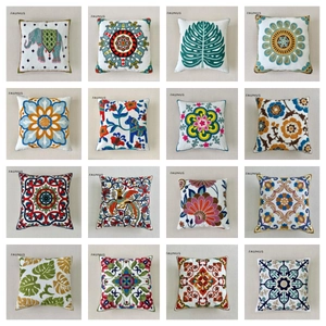 Collection of 16 floral and animal embroidered square pillow covers in vibrant colors